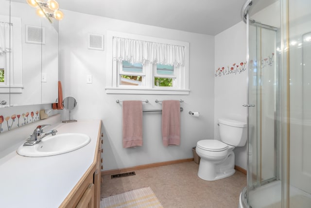 bathroom featuring vanity, an enclosed shower, and toilet