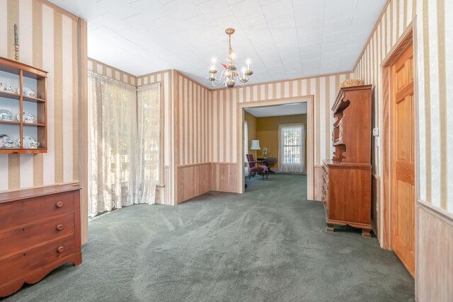 89 E Chicago St, Quincy, MI 49082 - carpeted empty room featuring wallpapered walls and a chandelier