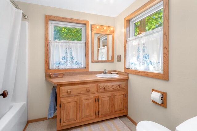 89 E Chicago St, Quincy, MI 49082 - bathroom featuring toilet, vanity, baseboards, and shower / bath combination with curtain