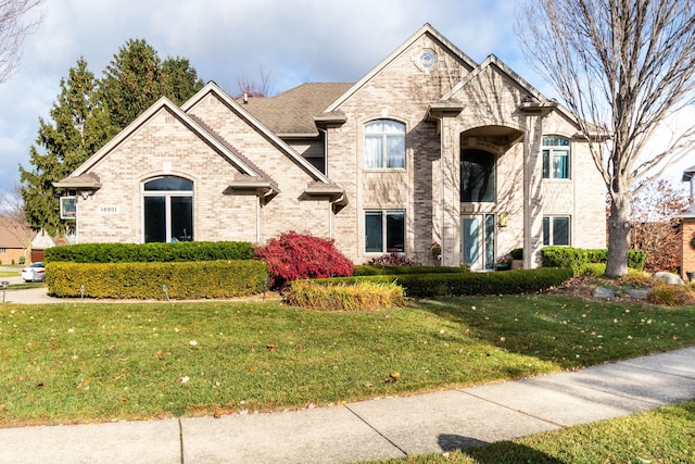 french country inspired facade featuring a front lawn