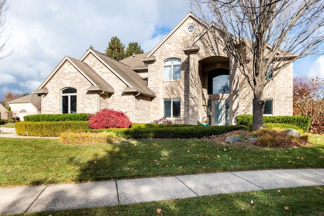 french country home featuring a front lawn