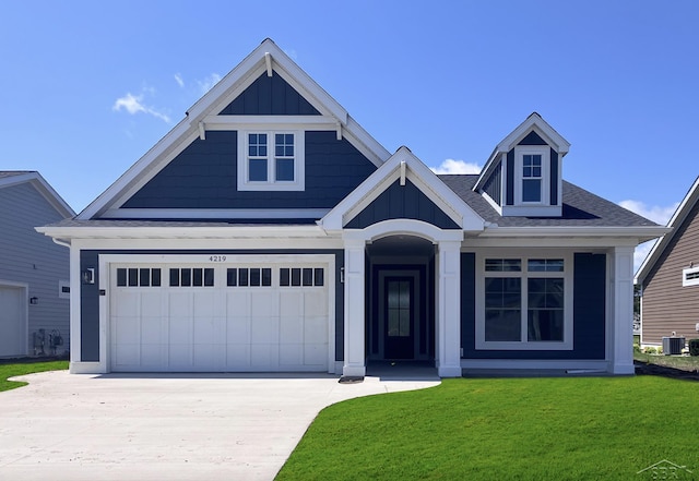 view of front of property featuring a front yard and cooling unit