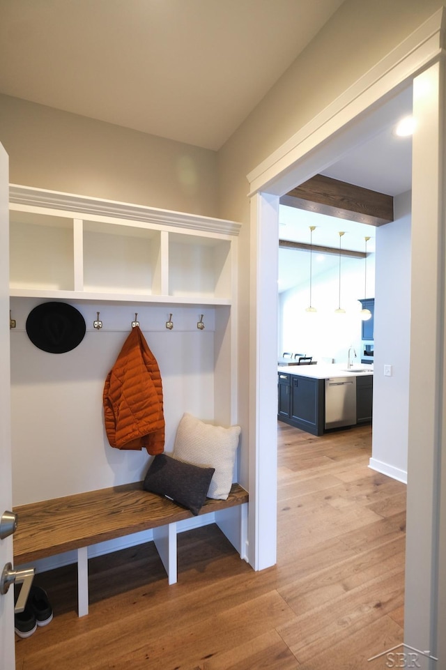 mudroom with light wood-type flooring and sink