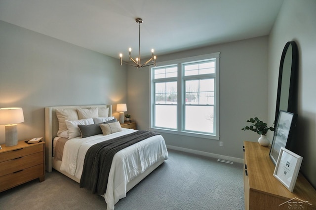 bedroom featuring carpet and a chandelier