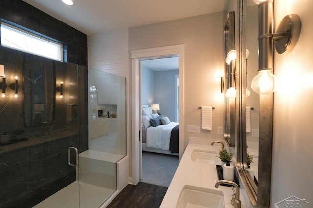 bathroom with hardwood / wood-style floors, walk in shower, and vanity