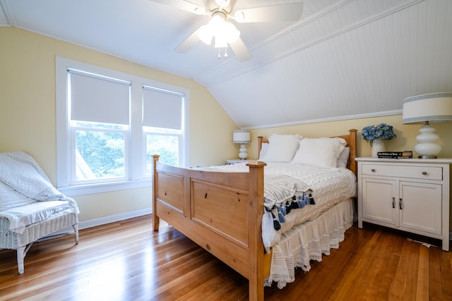 bedroom featuring ceiling fan, wood-type flooring, lofted ceiling, and ornamental molding