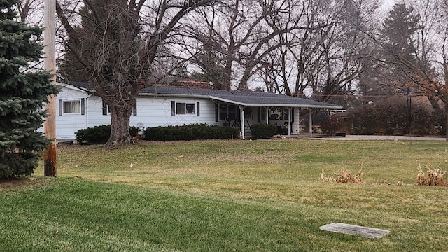 ranch-style home with covered porch and a front lawn