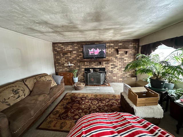 living room featuring a wood stove and a textured ceiling