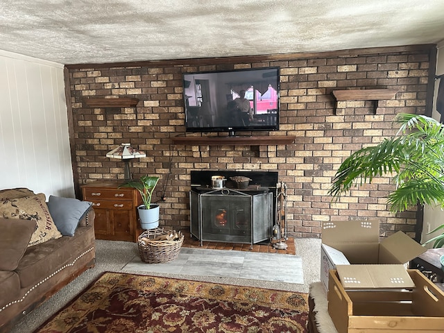 living room featuring a wood stove and a textured ceiling