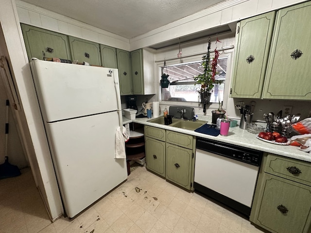 kitchen with sink, white appliances, and green cabinets