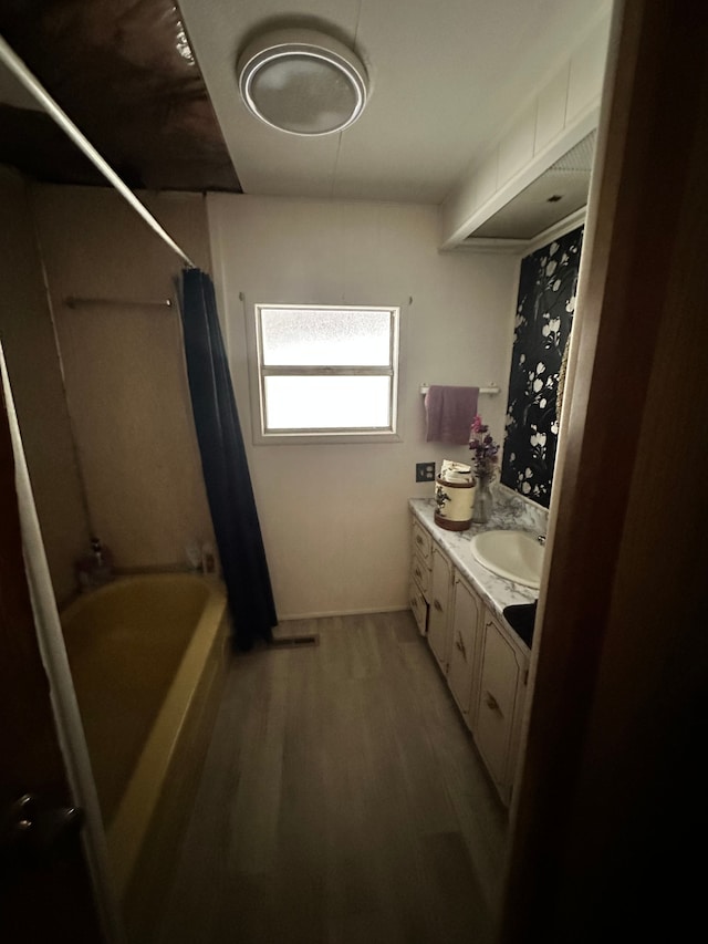 bathroom featuring vanity, hardwood / wood-style floors, and shower / bath combo