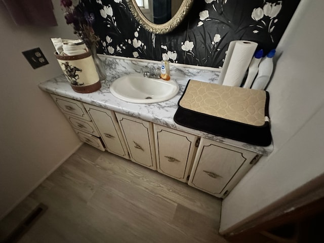 bathroom with vanity and hardwood / wood-style floors