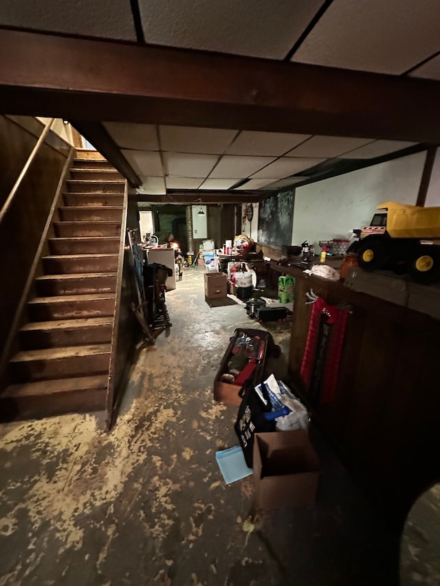 basement featuring a paneled ceiling