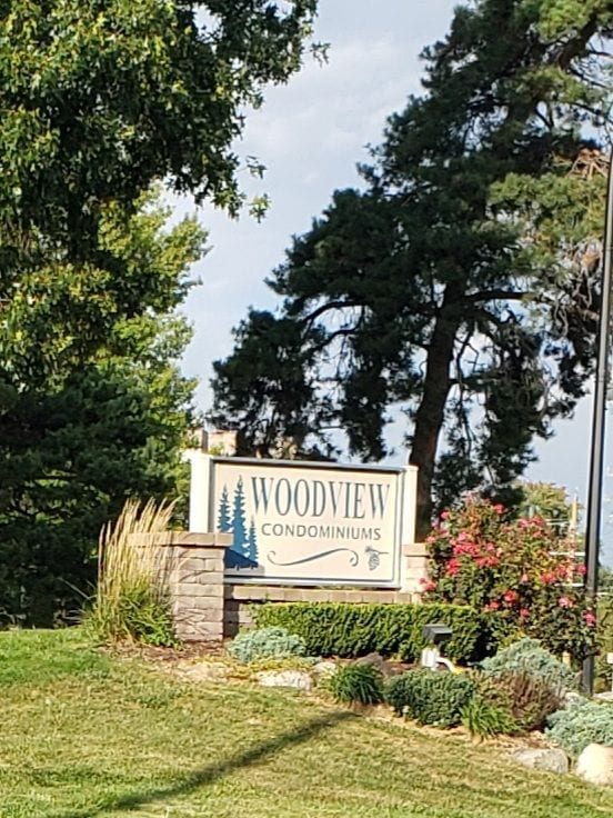 community / neighborhood sign with a lawn