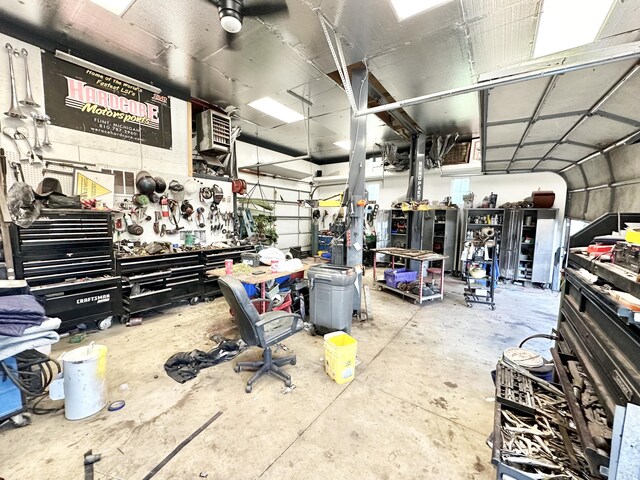 2715 Duck Lake Rd N, Highland, MI 48356 - garage with a workshop area and a heating unit