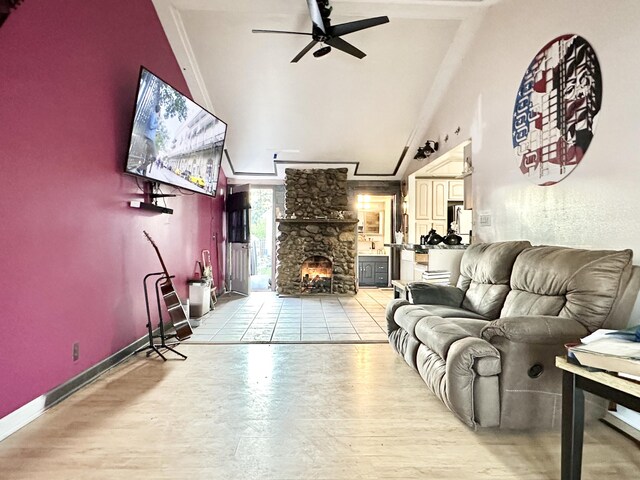 2715 Duck Lake Rd N, Highland, MI 48356 - living area with a fireplace, ceiling fan, high vaulted ceiling, light wood-style floors, and baseboards