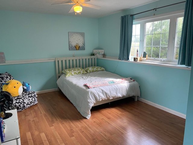 bedroom with hardwood / wood-style flooring and ceiling fan