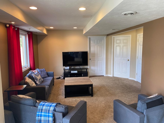 living room featuring carpet and a textured ceiling