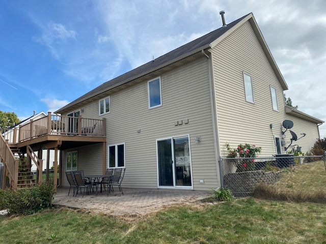 back of house with a patio area, a yard, and a wooden deck