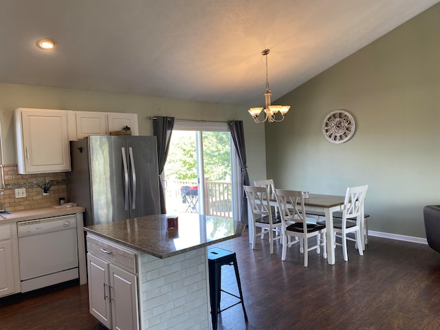 kitchen with stainless steel fridge, white cabinetry, a center island, and white dishwasher