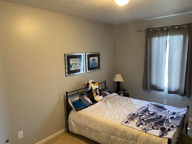 carpeted bedroom featuring a textured ceiling