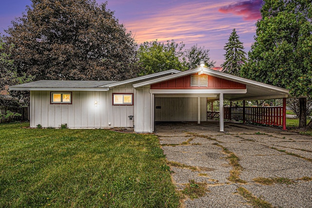 view of front of house with a yard and a carport