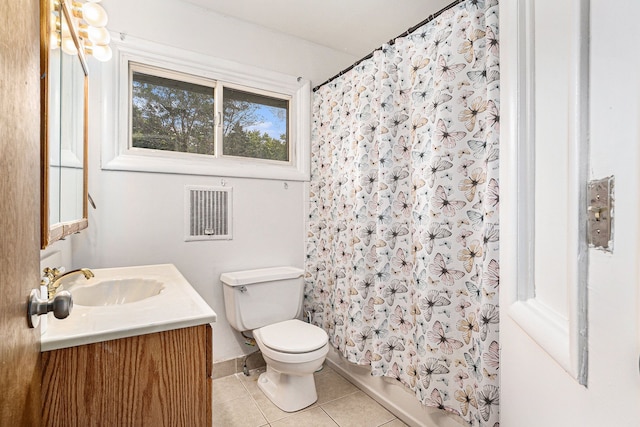 bathroom with tile patterned flooring, vanity, and toilet