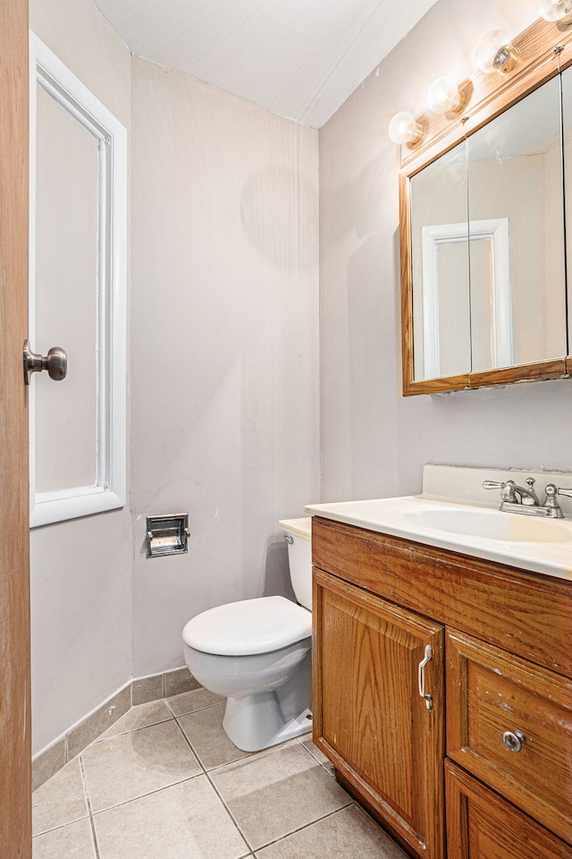 bathroom featuring tile patterned floors, vanity, and toilet