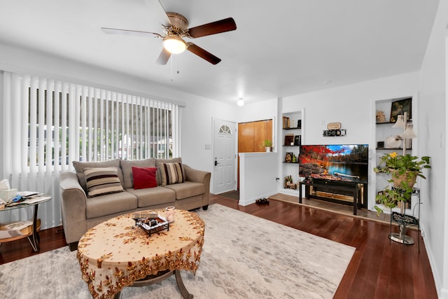 living room featuring ceiling fan, dark hardwood / wood-style flooring, and built in features