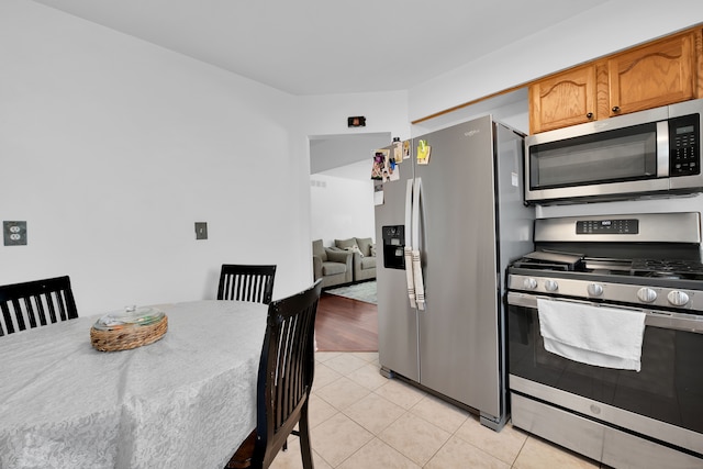 kitchen featuring stainless steel appliances and light hardwood / wood-style flooring