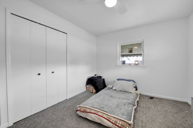 bedroom with ceiling fan, a closet, and carpet floors