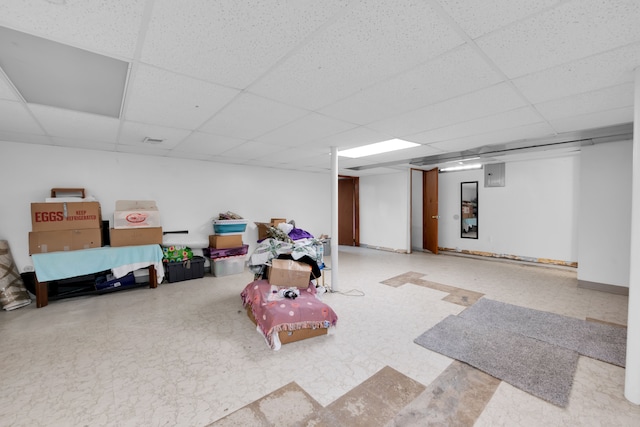 basement with a paneled ceiling