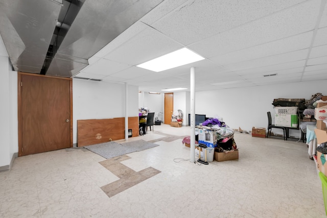 basement with a paneled ceiling