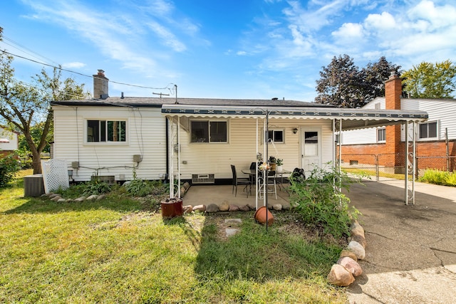 back of property featuring a yard, a patio area, and central air condition unit