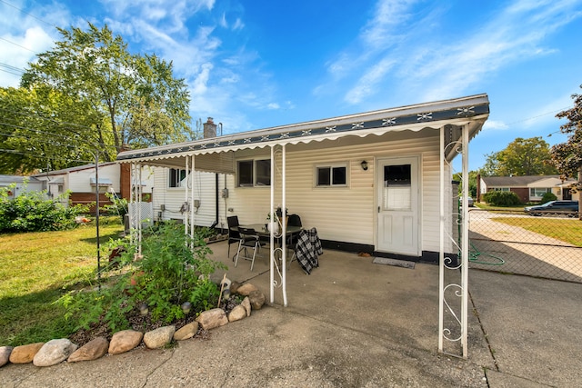 rear view of property with a patio area and a yard