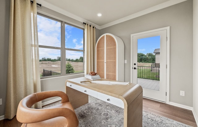 sitting room with ornamental molding and hardwood / wood-style floors