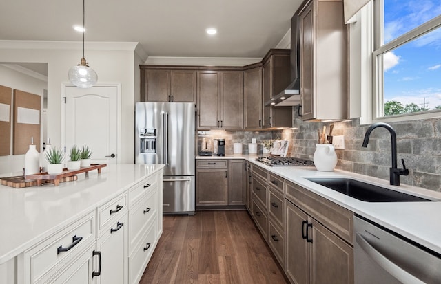 kitchen with white cabinets, appliances with stainless steel finishes, sink, hanging light fixtures, and crown molding