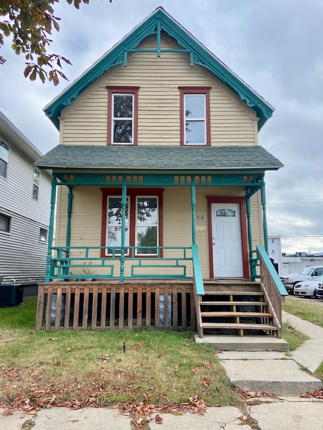 view of front of house with a porch and cooling unit