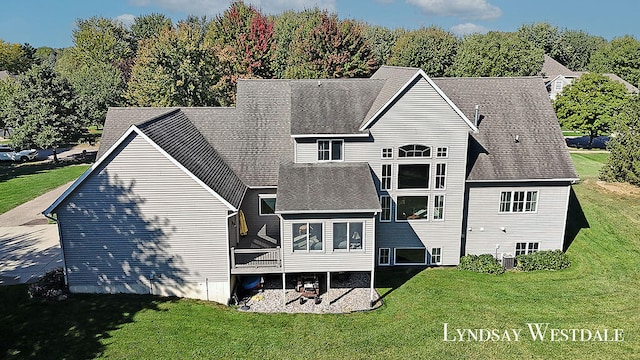 rear view of property featuring a yard and a patio