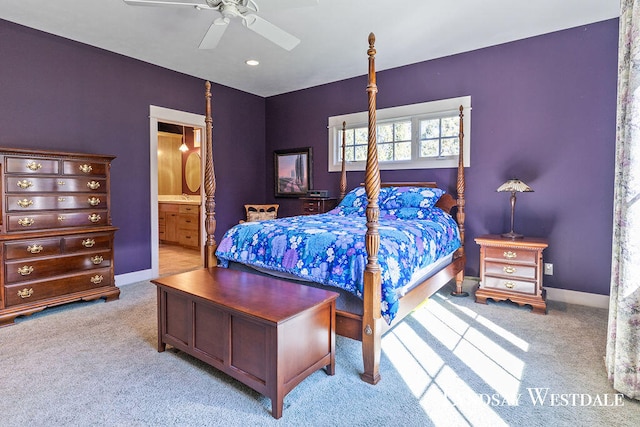 carpeted bedroom with ensuite bathroom and ceiling fan