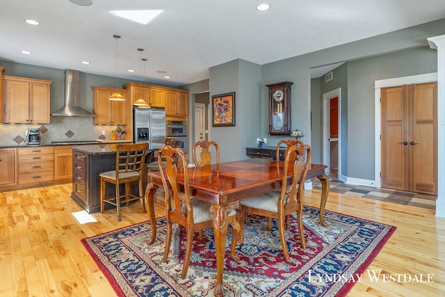 dining space featuring light wood-type flooring