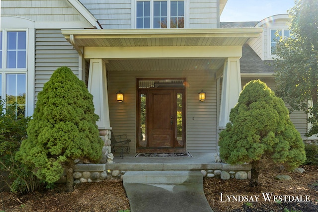 view of exterior entry featuring a porch