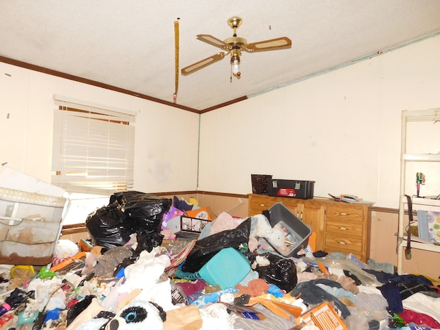 bedroom featuring ceiling fan and ornamental molding