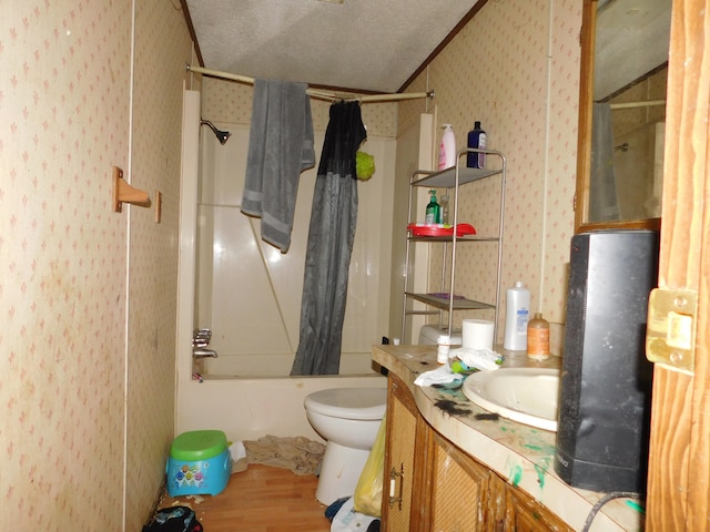 full bathroom with crown molding, wood-type flooring, a textured ceiling, shower / bath combo with shower curtain, and vanity