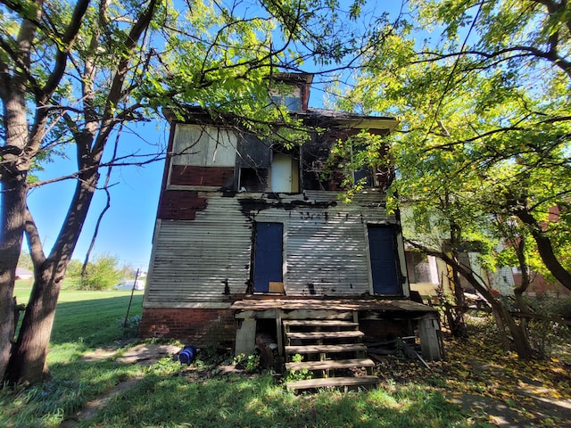 back of property featuring a lawn