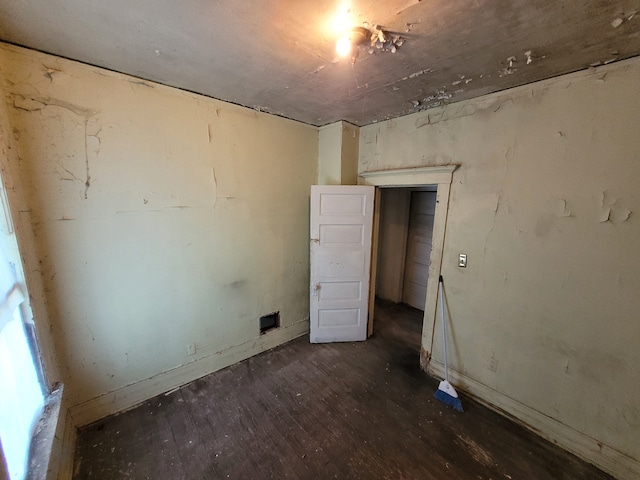 unfurnished room featuring dark hardwood / wood-style floors