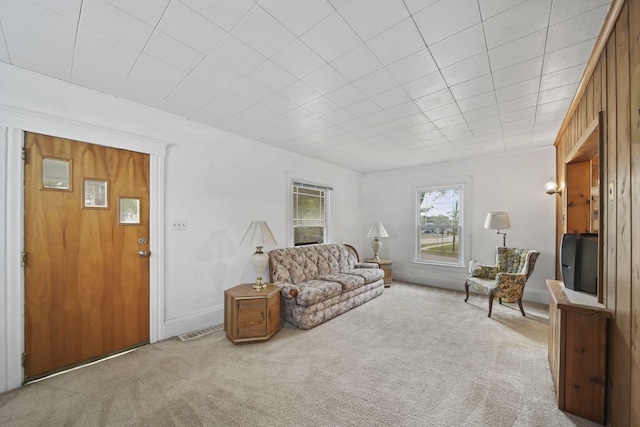 living room featuring light colored carpet and ornamental molding