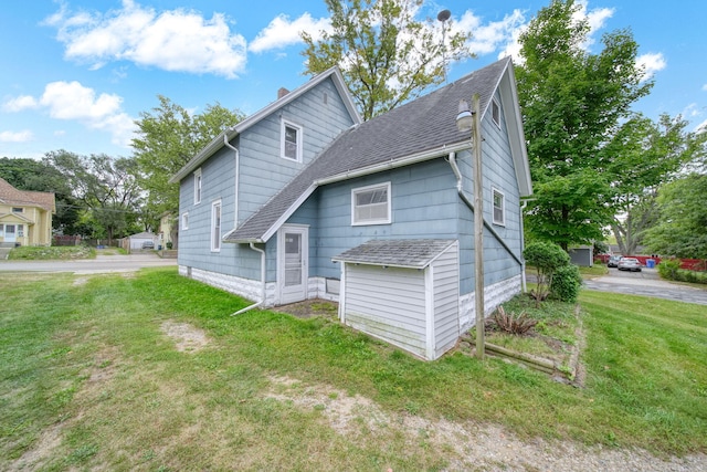 rear view of house with a lawn