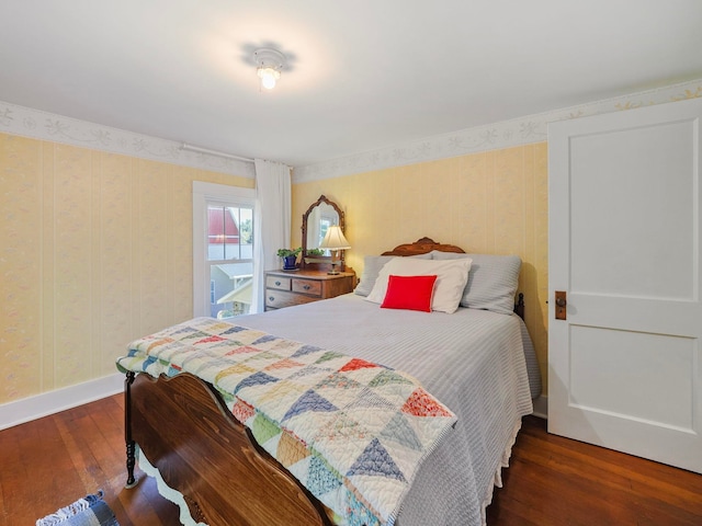 bedroom with dark hardwood / wood-style floors