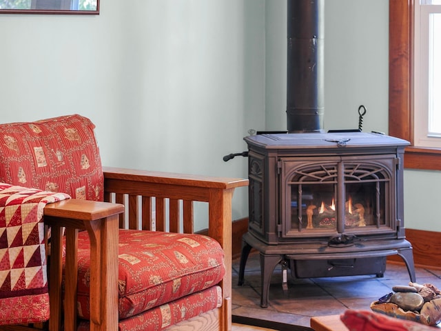 interior space featuring tile patterned floors and a wood stove